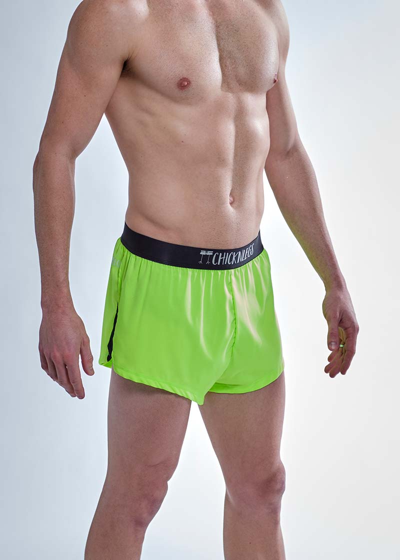 Side split view of the ChicknLegs men's 2 inch neon green split running shorts.