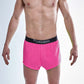 Front closeup view of the men's neon pink 2 inch split running shorts.