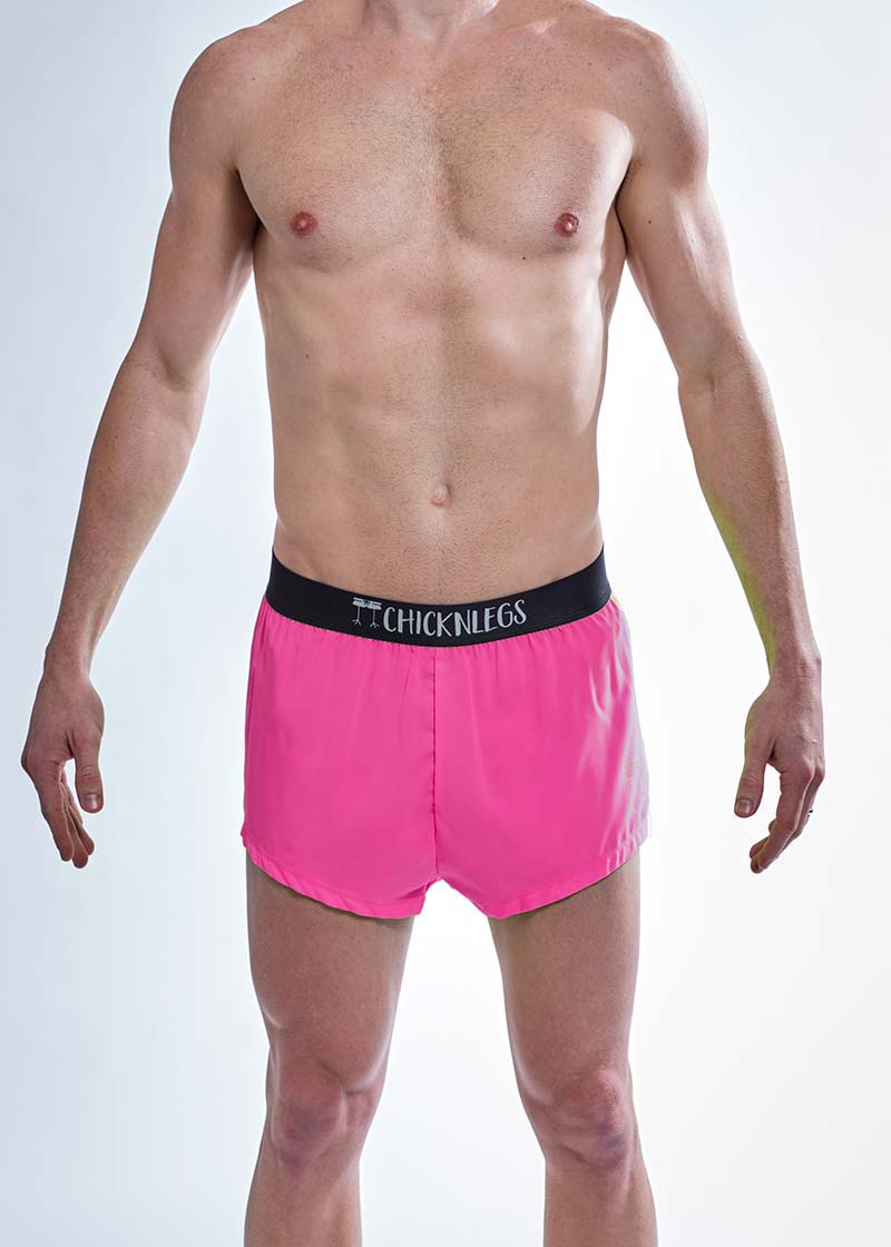 Front closeup view of the men's neon pink 2 inch split running shorts.