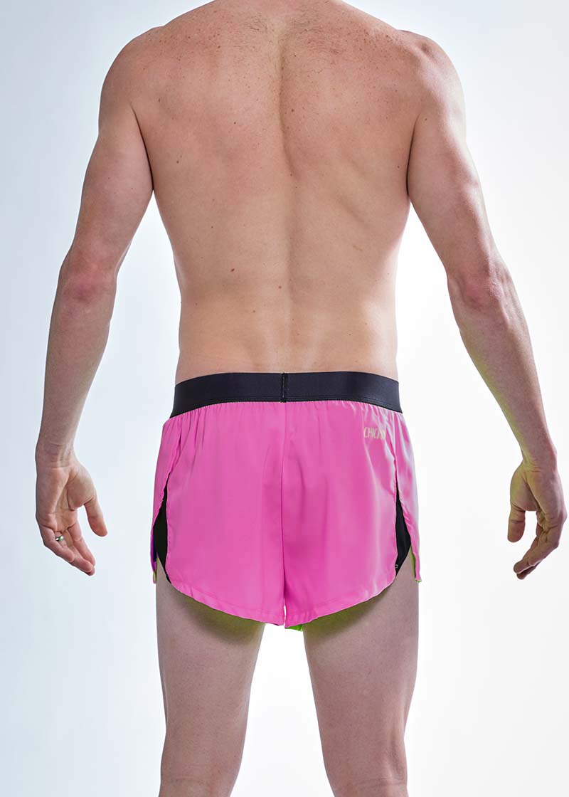 Rear closeup view of the men's neon pink 2 inch split running shorts.