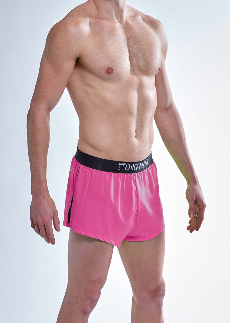 Side closeup view of the men's neon pink 2 inch split running shorts.