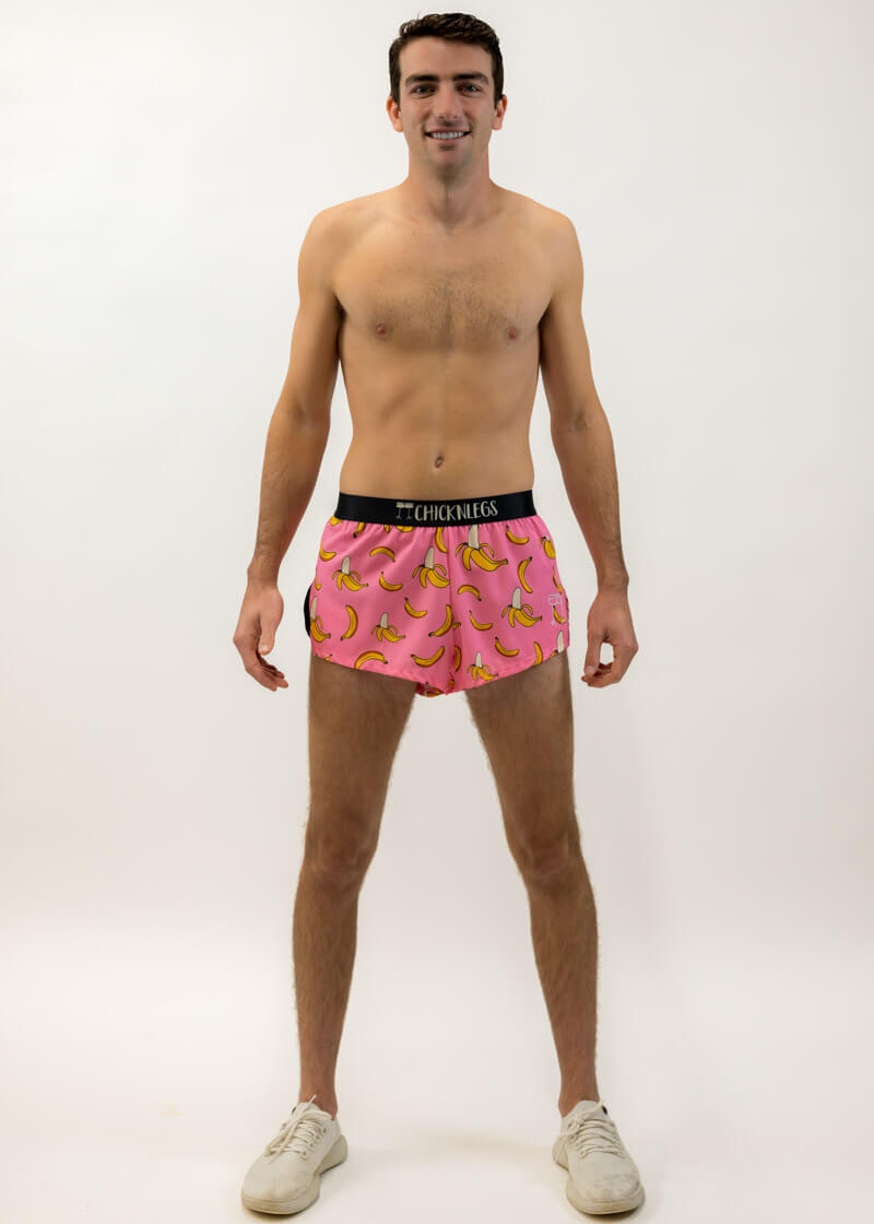 Full body view of the men's pink bananas 2 inch split running shorts from ChicknLegs.