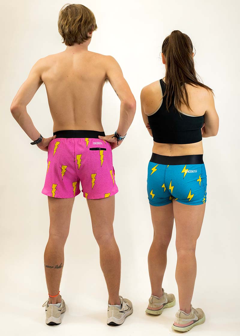 Back view of the men's and women's lightning bolt running shorts. The men's 4 inch split running shorts and women's 3" compression shorts are shown.