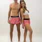 Group shot of the men's and women's pink bananas running shorts.