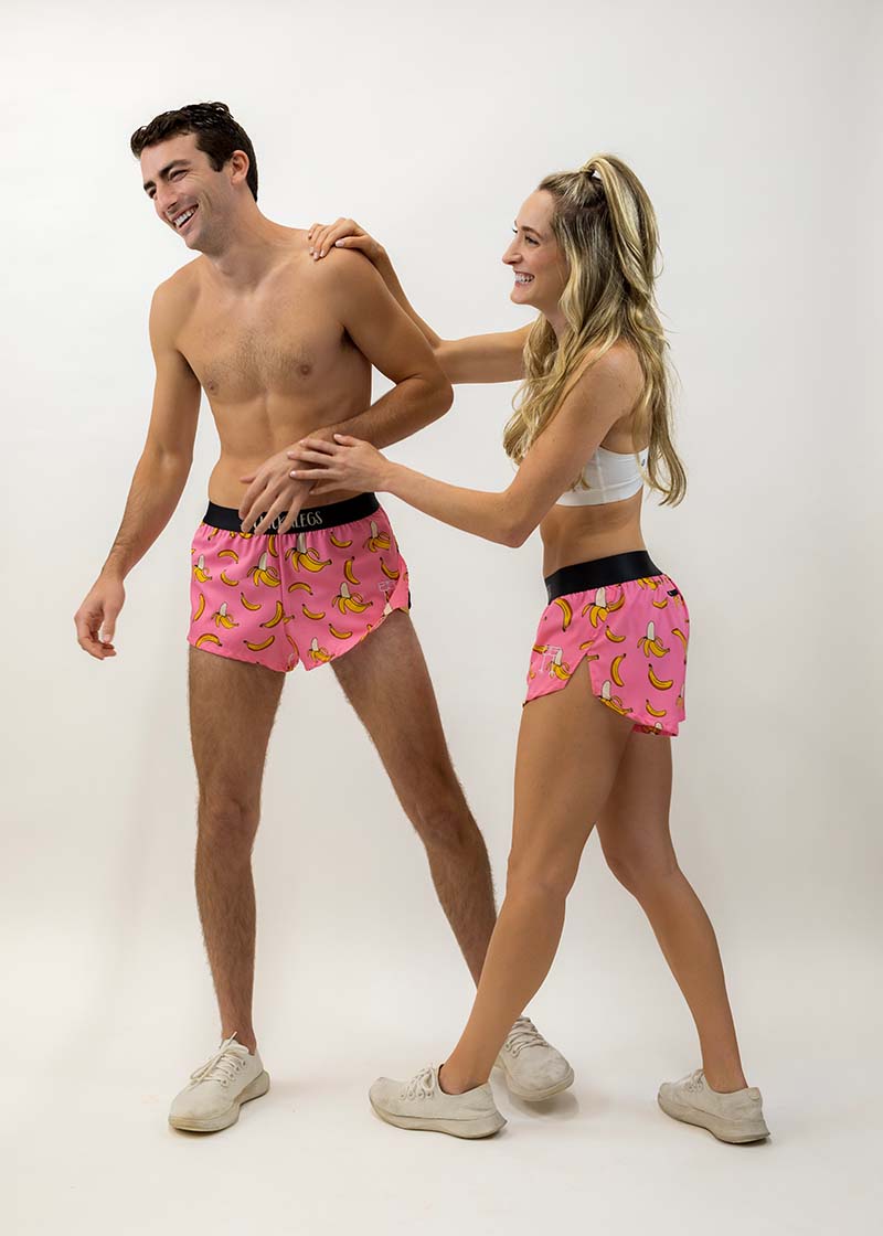 Group shot of runners laughing wearing the men's and women's pink bananas running shorts.
