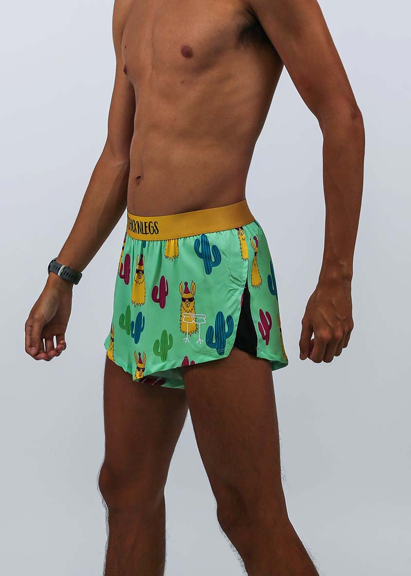 Closeup side view of the logo and split on the men's 2 inch green llama running shorts.