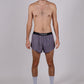 Full body view of the ChicknLegs men's heather grey 2 inch split running shorts.