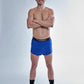 Full body view of the chicknlegs men's 2 inch royal blue split running shorts.