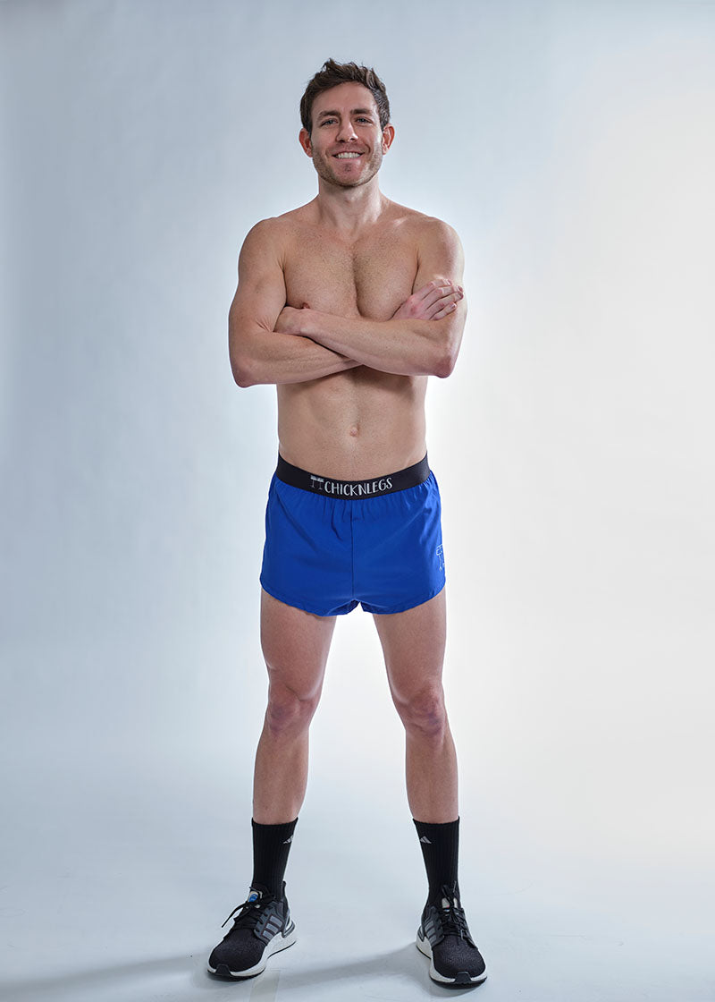 Full body view of the chicknlegs men's 2 inch royal blue split running shorts.