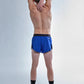 Full body rear stretching photo of the chicknlegs men's 2 inch royal blue split running shorts.