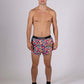 Full body view of the ChicknLegs men's tie-dye 2 inch split running shorts.