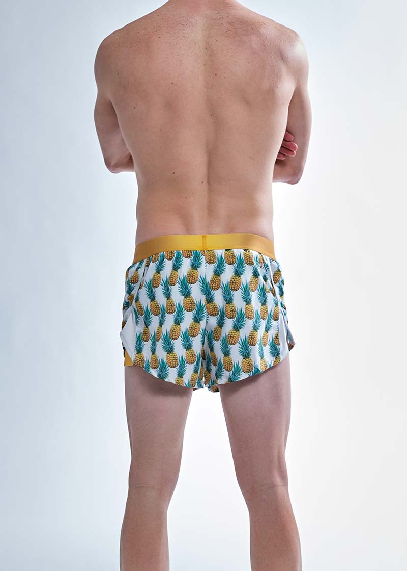 Rear view of the chicknlegs men's trippy pineapples 2 inch split running shorts.