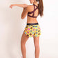 ChicknLegs women's donuts 1.5" split running shorts back view with zipper pocket while doing arm stretch.