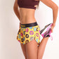 ChicknLegs women's donuts 1.5" split running shorts side view while doing hamstring stretch.
