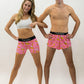 Runners posing in the men's and women's pink bananas running shorts from ChicknLegs.