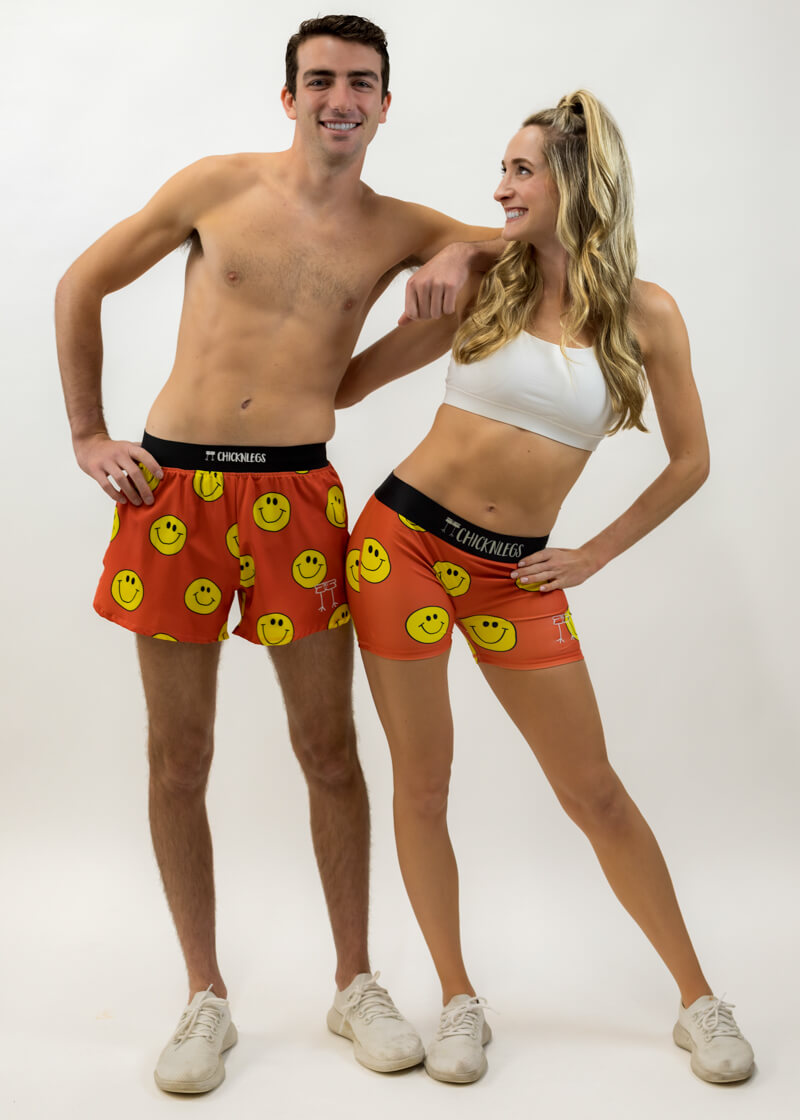 Group photo of the men's and women's smiley face running shorts from ChicknLegs.