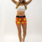 Runner fixing her hair wearing the women's smiley face 3 inch compression running shorts from ChicknLegs.