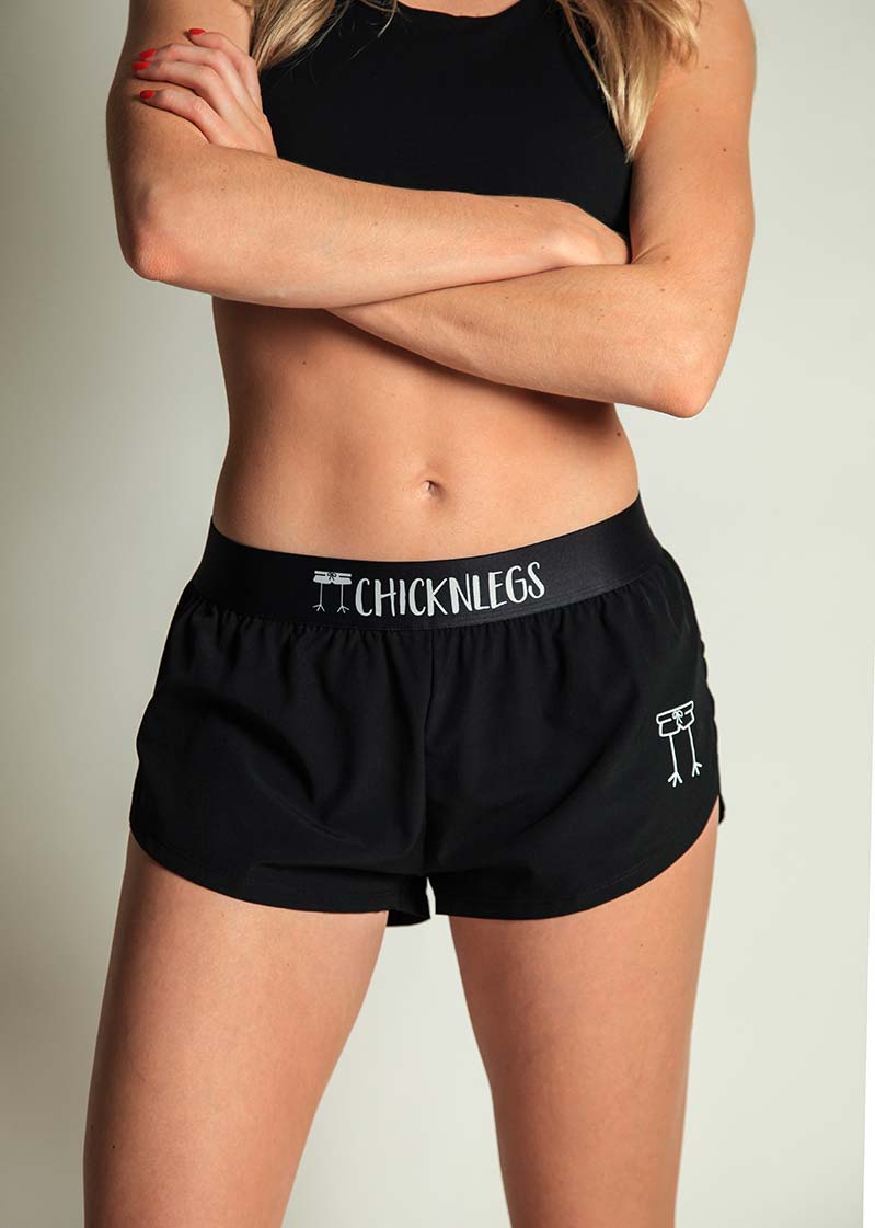 ChicknLegs women's black 1.5" split running shorts front closeup view.