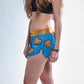 Side logo view of the chicknlegs women's 1.5" split running shorts.
