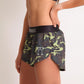 ChicknLegs women's green camo 1.5" split running shorts with a side view showcasing our logo on the left thigh.