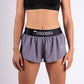 Front closeup view of the ChicknLegs women's 1.5" heather grey split running shorts.