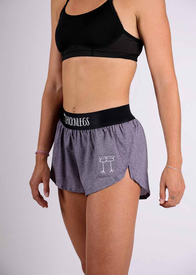 Logo side closeup view of the ChicknLegs women's 1.5" heather grey split running shorts.