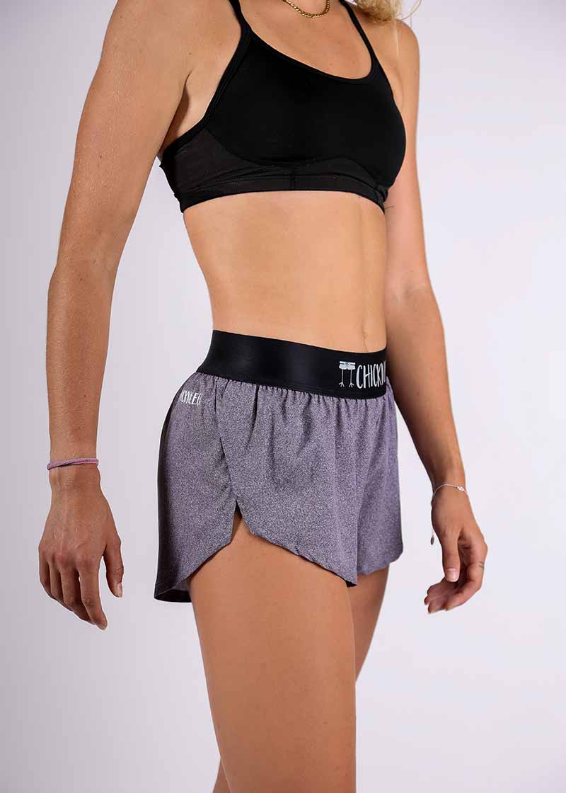 Side closeup view of the ChicknLegs women's 1.5" heather grey split running shorts.