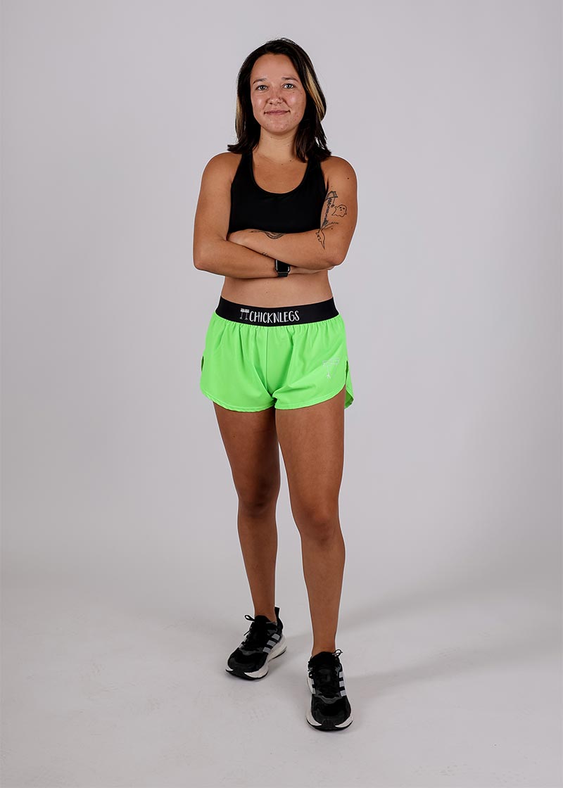 Full body shot of the ChicknLegs women's neon green split running shorts.