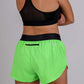 Rear view of the ChicknLegs women's neon green 1.5 inch split running shorts showcasing the back zipper pocket.