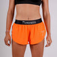 Front closeup shot of the women's 1.5 inch neon orange split running shorts.