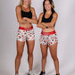 ChicknLegs women's 1.5" pasta night split running shorts full body group shot with arms crossed.
