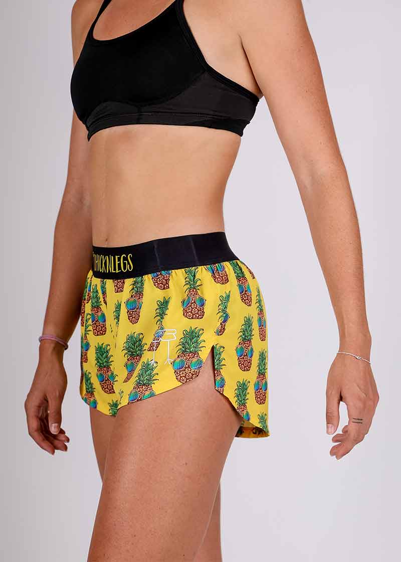 Side closeup view showing the logo of the ChicknLegs pineapple express 1.5 inch split running shorts.