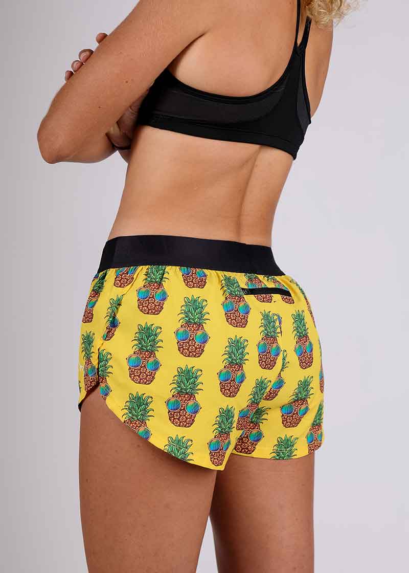 Rear closeup view from the left of the ChicknLegs pineapple express 1.5 inch split running shorts.