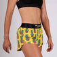 Side closeup view of the ChicknLegs pineapple express 1.5 inch split running shorts.