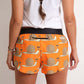 ChicknLegs women's snail's pace 1.5" split running shorts rear view paired with a white tank top.