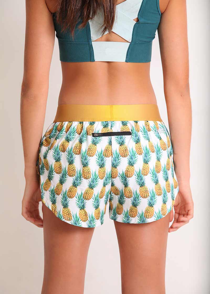 ChicknLegs women's trippy pineapples 1.5" split running shorts rear view.