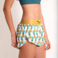 ChicknLegs women's trippy pineapples 1.5" split running shorts side view.