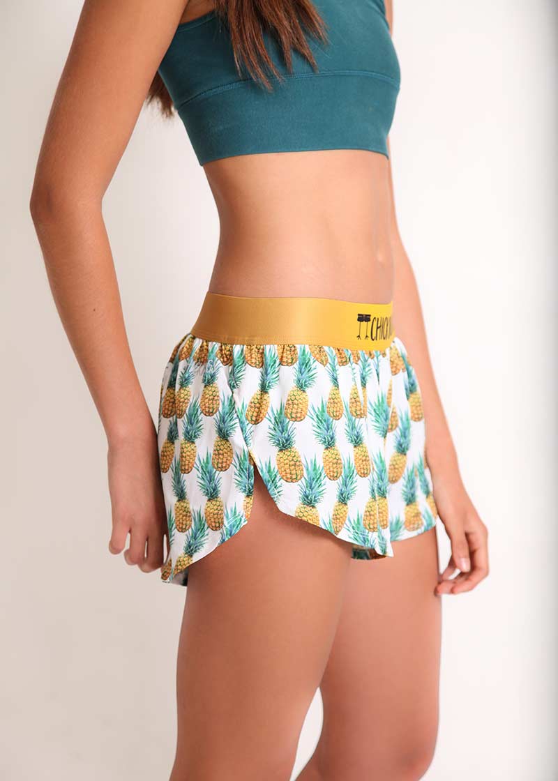 ChicknLegs women's trippy pineapples 1.5" split running shorts side view.