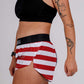 Logo side closeup view of the ChicknLegs women's USA split running shorts.