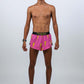 Full body shot of the men's 2 inch hot pink bolts running shorts.