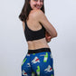 Back view of the women's 3 inch blue sharks compression shorts with model smiling.
